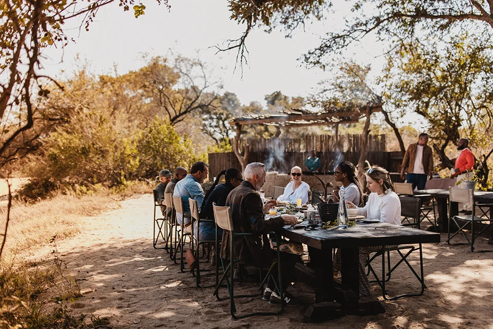 Corporate safari group enjoying an outdoor bush lunch at Tanda Tula in South Africa