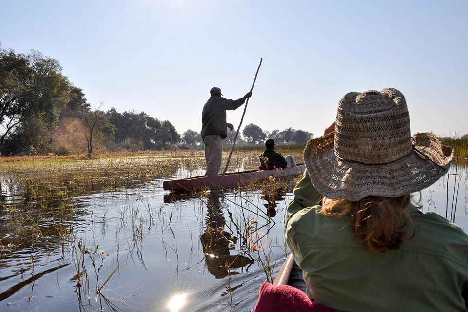 Guest enjoying a traditional mokoro excursion through the waterways of the Okavango Delta