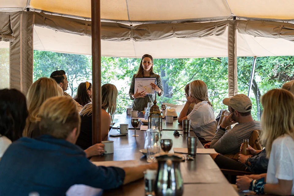 Corporate safari group attending a presentation at Cottar's Bush Villa in Kenya