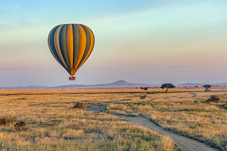 Hot-air balloon floating over the grasslands of Serengeti National Park, Tanzania