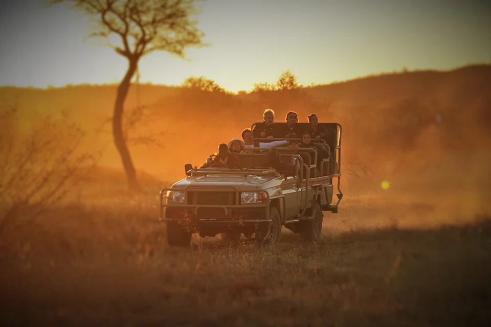 Guests on a sunset game drive at Okonjima Nature Reserve, Namibia