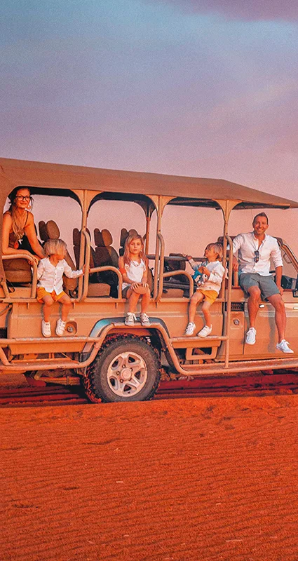 Family enjoying a sunset safari in an open game-drive vehicle at Kalahari Anib Lodge, Namibia