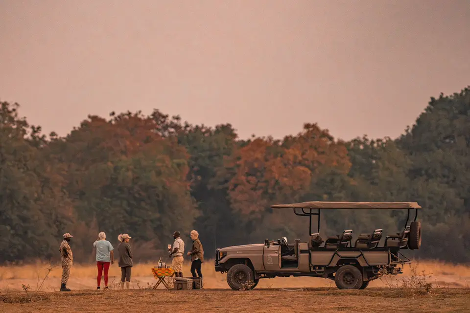 Sunset on safari, game drive with guests have a sundowner