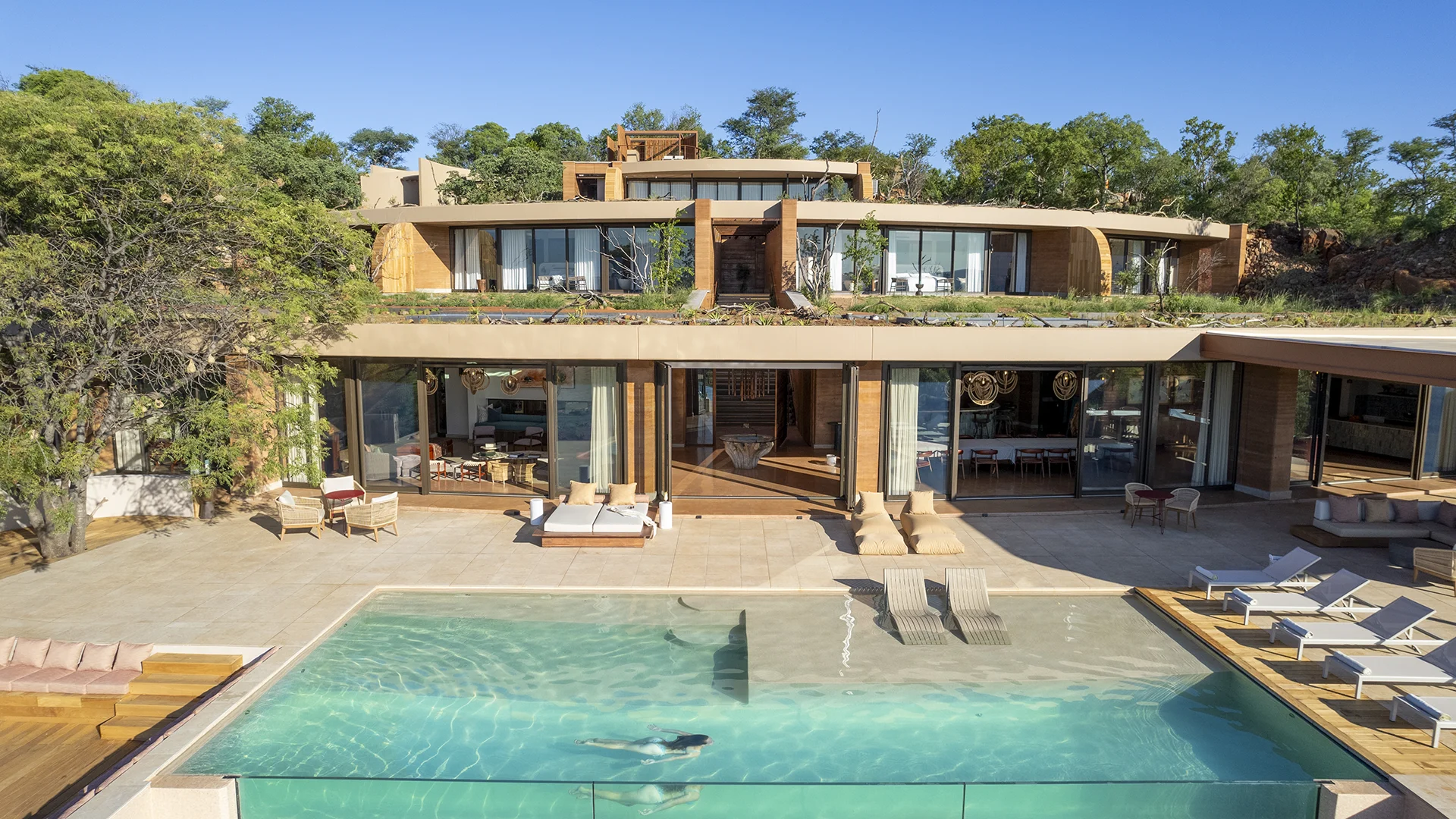 Melote House with a large swimming pool and multi-level suites surrounded by bushveld