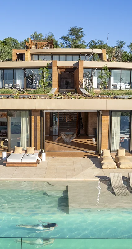 Melote House with a large swimming pool and multi-level suites surrounded by bushveld