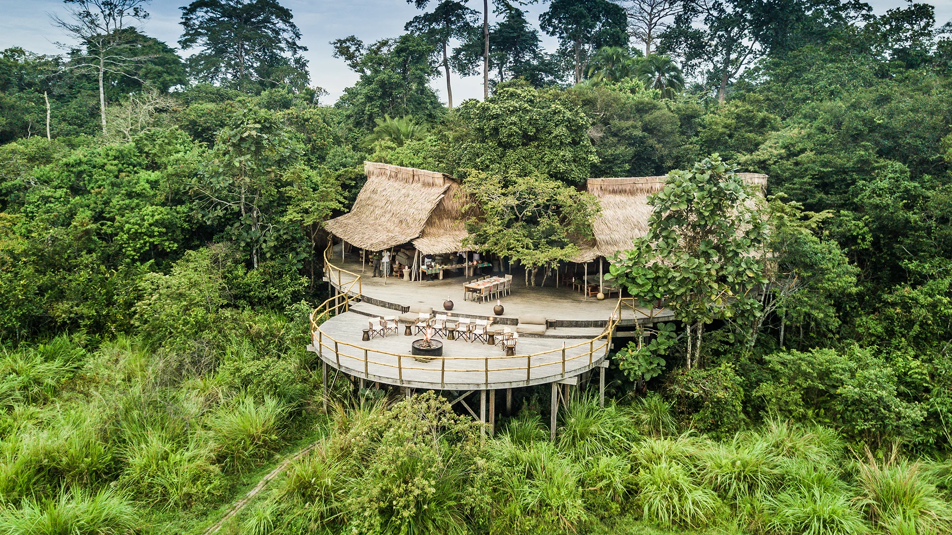 Aerial view of Lango Camp’s thatched main guest area and deck surrounded by rainforest in Odzala-Kokoua National Park, Republic of the Congo
