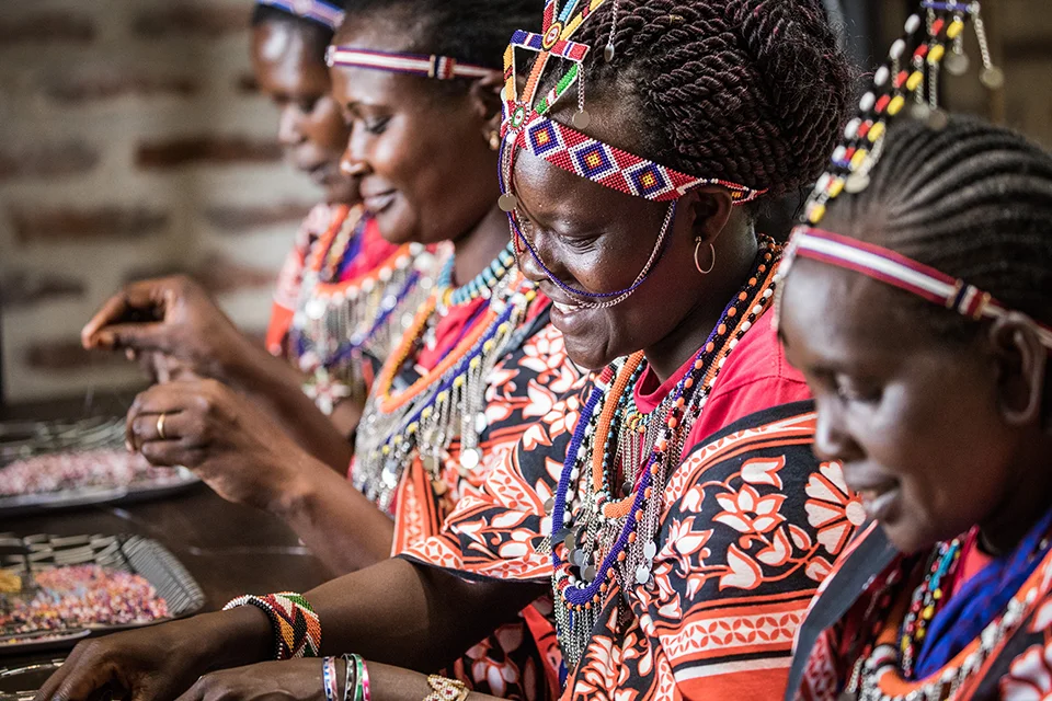 Maasai women creating traditional beadwork at the Angama Mara beading studio in Kenya