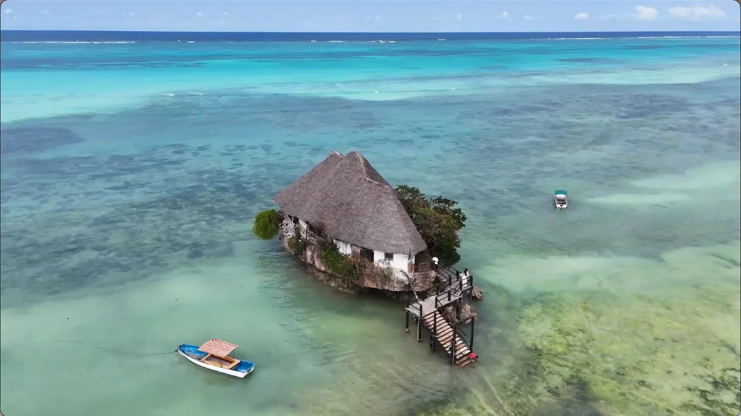 The Rock Restaurant perched on a rock in the turquoise waters off Michamvi Pingwe Beach, Zanzibar, Tanzania