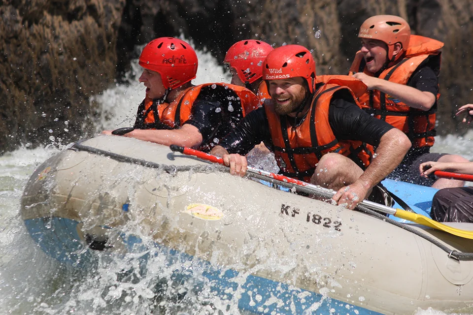Adventurers white-water rafting through rapids on the Zambezi River near Victoria Falls